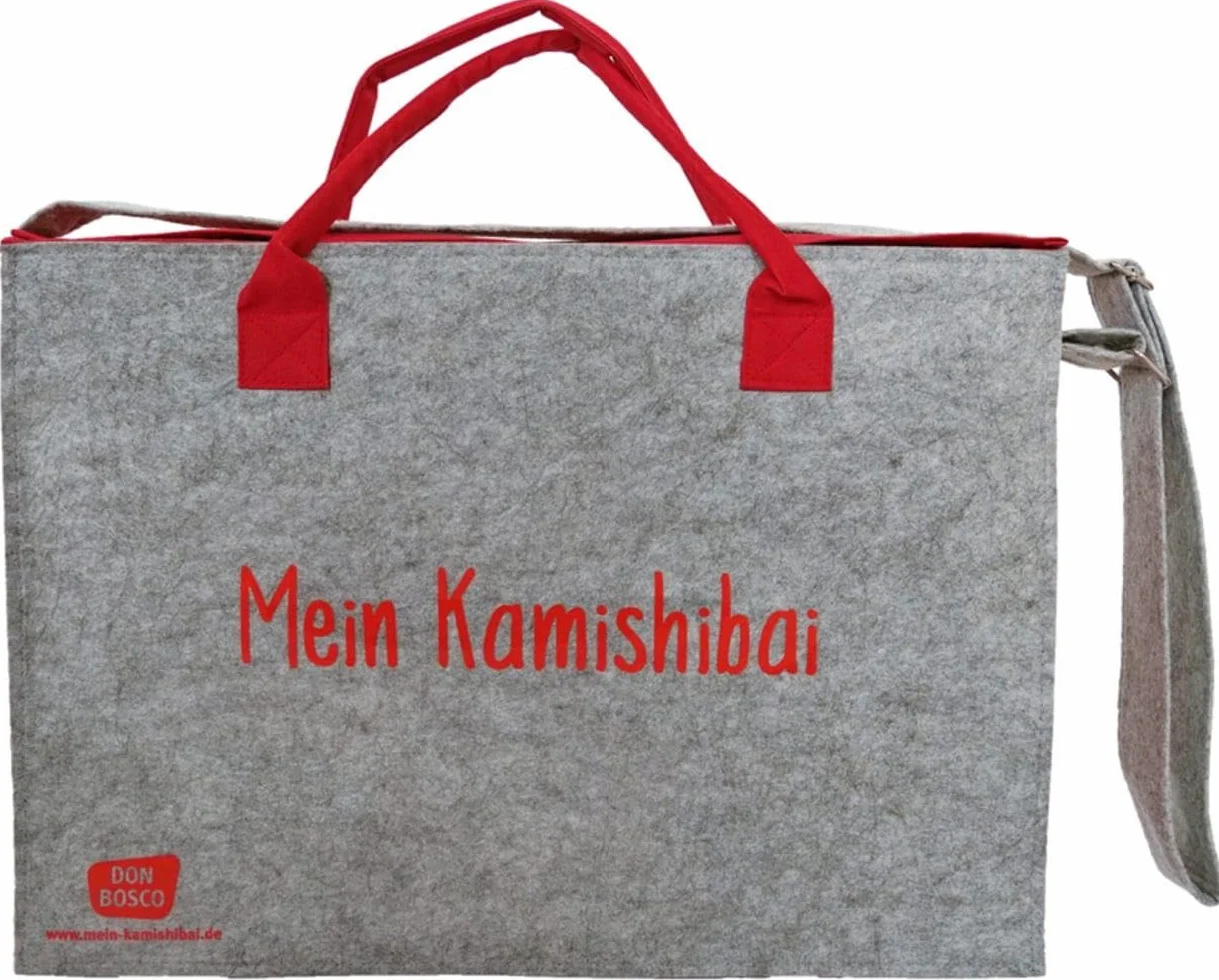 Tragetasche und Umhängetasche "Mein Kamishibai": Modell 2022. Grauer Filz, rote Seitenteile, verstärkter Boden, Klettverschluss, zwei Tragegriffe für die Hand, längenverstellbarer Schulterriemen